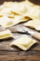 Uncooked ravioli on the wooden table