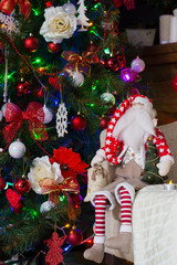 Toy santa claus and Christmas tree with holiday decorations