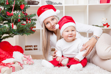 Obraz na płótnie Canvas Mother with baby boy celebrating Christmas