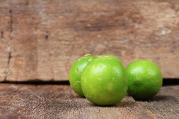 lemon with green closeup Select focus with shallow depth of field  on wooden table