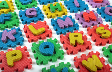 Fototapeta na wymiar Cut out letters of toy plastic alphabet