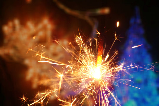 Sparkler and colorful bokeh christmas new year background
