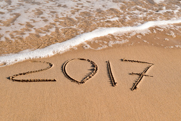2017, as the new year, in the sand of a beach