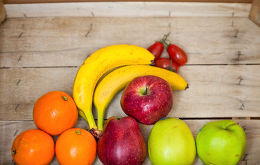 Fresh fruits on wooden background.