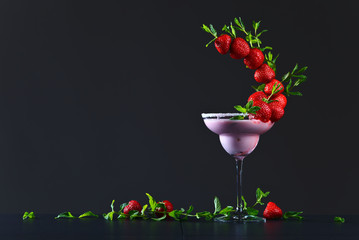 strawberry cocktail with  peppermint leaves on a black backgroun