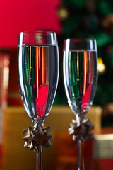 Two glasses with champagne and Christmas ornaments