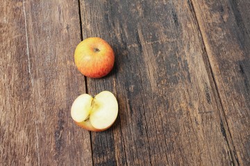 red apple and slice on wooden background, top view with copy space 