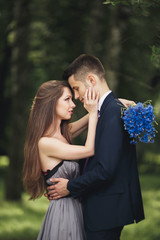 Young beautiful couple, girl with perfect dress posing in park