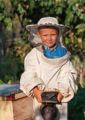 beekeeper a young boy who works in the apiary