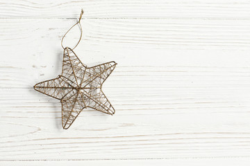 Fototapeta na wymiar christmas golden star on stylish white rustic wooden background.