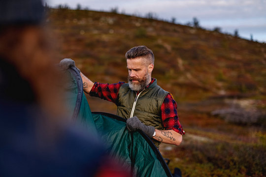 Man pitching tent 

