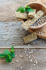 Candied sunflower seeds and mint in a wooden bowl.