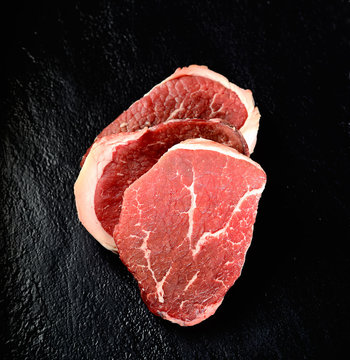 raw beef steak marble on a black background