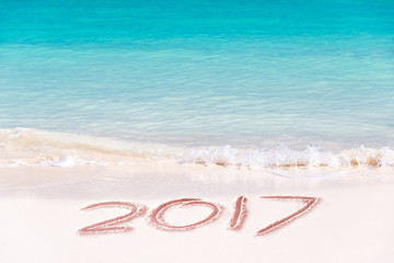 2017 written on the sand of a beach, travel 2017 new year concept