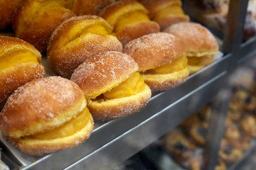 Rows of Bola de Berlim (Portuguese doughnut) on tray, Lisbon, Portugal