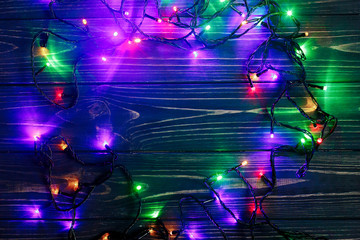 christmas frame of garland lights. colorful stylish border on bl