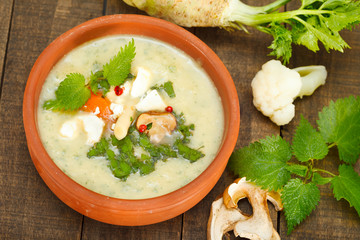 Top view of vegetable, mushroom and cheese soup. Nettle leaves cream soup.