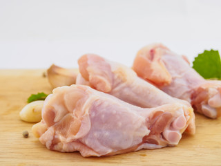 Fresh chicken drumstick group  on wood plate
