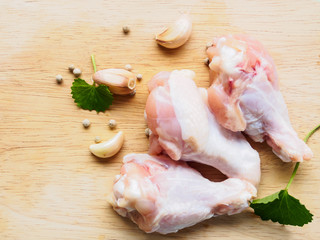 Top view chicken drumstick with ingredient on wooden background