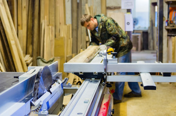 Fototapeta premium Woodworking machine with a circular saw in the carpentry workshop