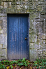 Old blue door in stone wall