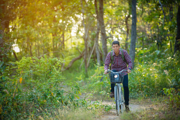tourist riding bicycle on the forest road