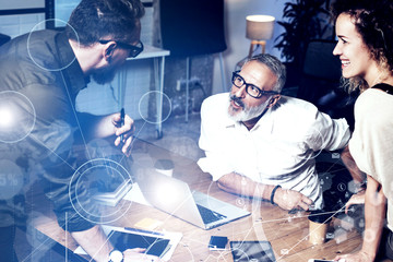 Concept of digital screen with virtual connection icon,diagram, graph interfaces.Young team coworkers making great work discussion in modern office.Business people meeting photo.Horizontal.