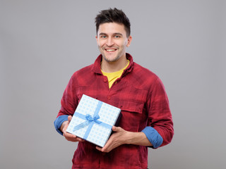 Happy young man with a gift