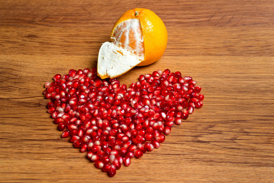 Heart of red sweet beans granana - a declaration of love on Valentine's Day. Ripe ochishenny Mandarin. A gentle feeling of love.