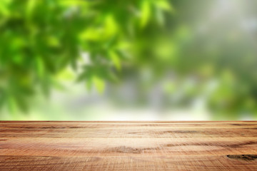 Wooden empty and blur green forest background.