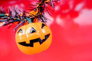 Halloween pumpkin against red background.