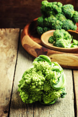 Whole green broccoli cabbage romanesco, vintage wooden backgroun
