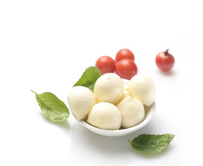 mozzarella, basil and cherry tomatoes on a white background
