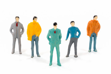 Miniature figures of businessman on white background