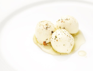Top view of mozzarella cheese with cherry tomatoes and basil on a black slate surface
