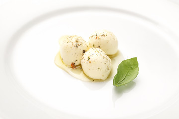 Top view of mozzarella cheese with cherry tomatoes and basil on a black slate surface