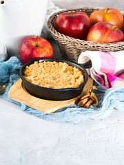 Home made apple crumble in cast iron skillet. Vertical