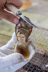 Open grilled Oyster with knife