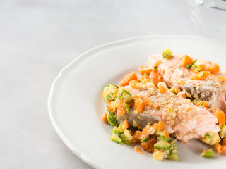Steamed salmon with carrots and courgettes