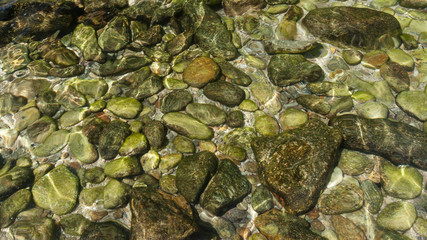 Pebbles in the crystal clear water.