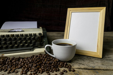 typewriter and coffee on wood background