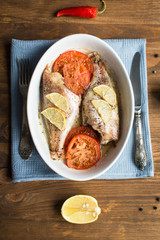 Baked sea bass with tomatoes and lemon