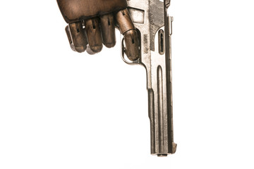 A gun is held by a black hand. Metaphor of wrath, capital sin. Isolated on white background. With...