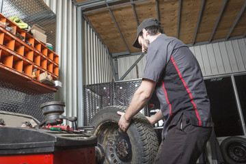 Mechanic working on car in his shop