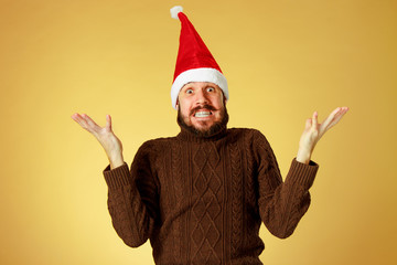 Surprised christmas man wearing a santa hat