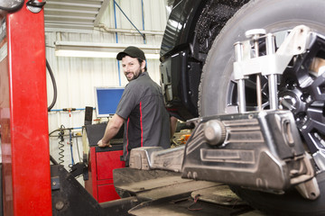 Fototapeta na wymiar Mechanic working on car in his shop