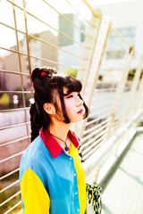 Half length portrait of young beautiful asian millennial woman outdoor in the city, overlooking...