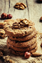 Chocolate cookies with nuts, vintage wooden background, selectiv