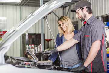 Plakat auto mechanic and female customer in garage