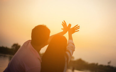a silhouette of a man and woman holding hands with each other, w